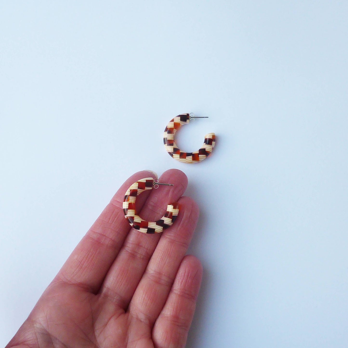 Side view of chunky honey checker acetate hoop earrings