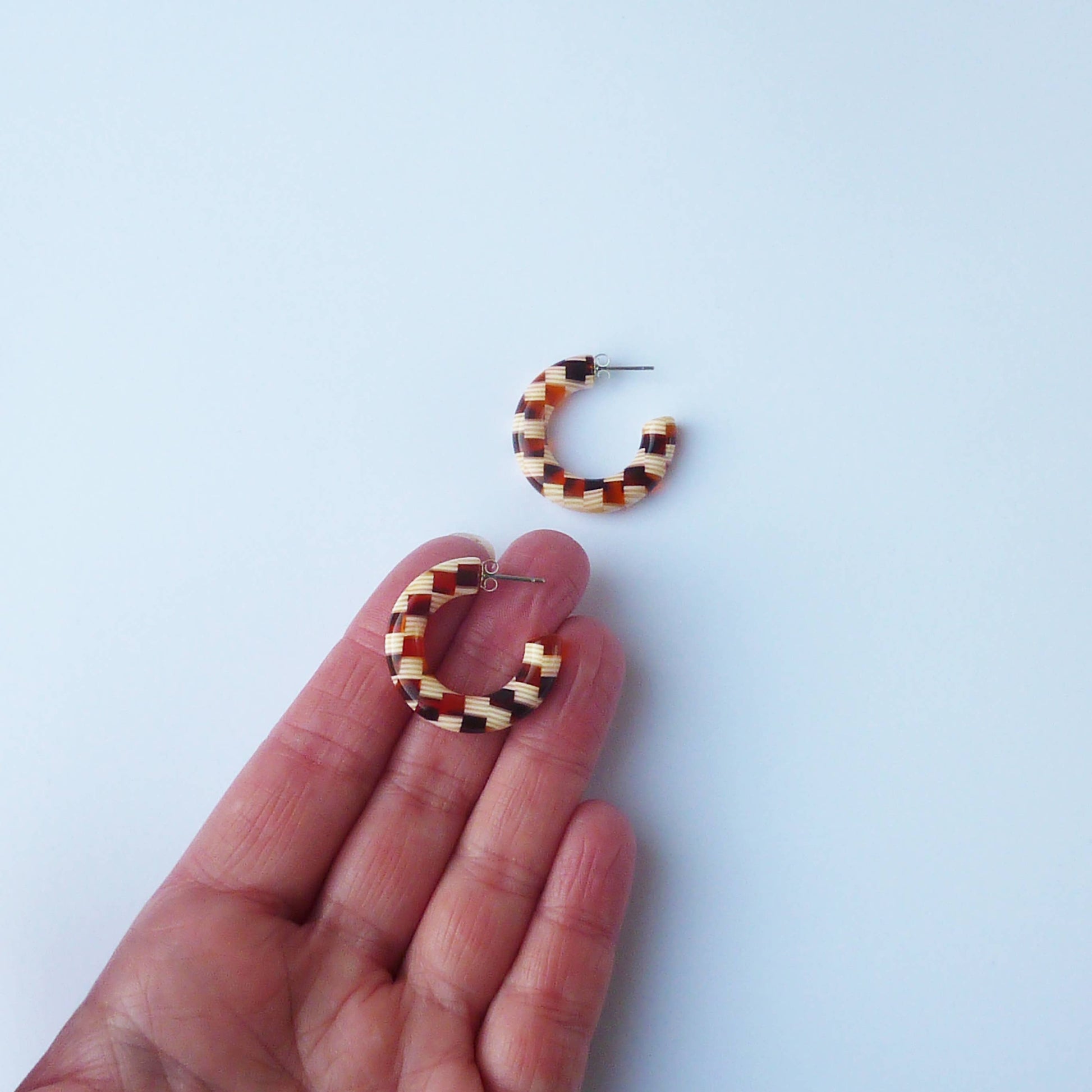 Side view of chunky honey checker acetate hoop earrings