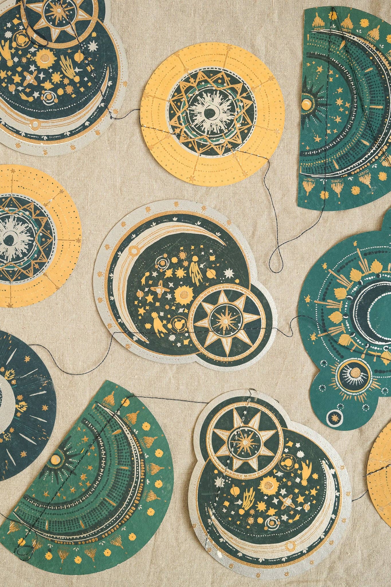 Close up of hand screen-printed paper star and moon garland