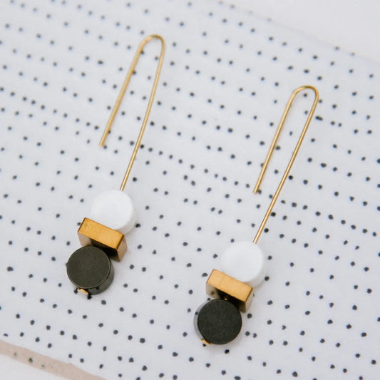 Elegant monochrome and gold double bead earrings by Copper Bee with black and white ceramic beads and solid brass cuboid on gold-plated wires, handmade in the UK.