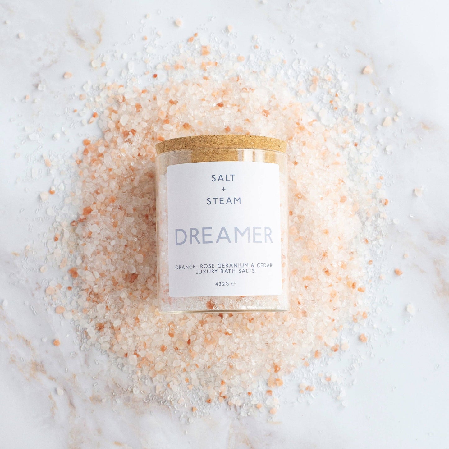 Floral and woody scented vegan bath salts in plastic-free packaging.
