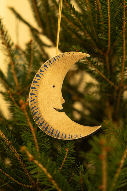 Close up of hand screen printed golden Man on the Moon decoration