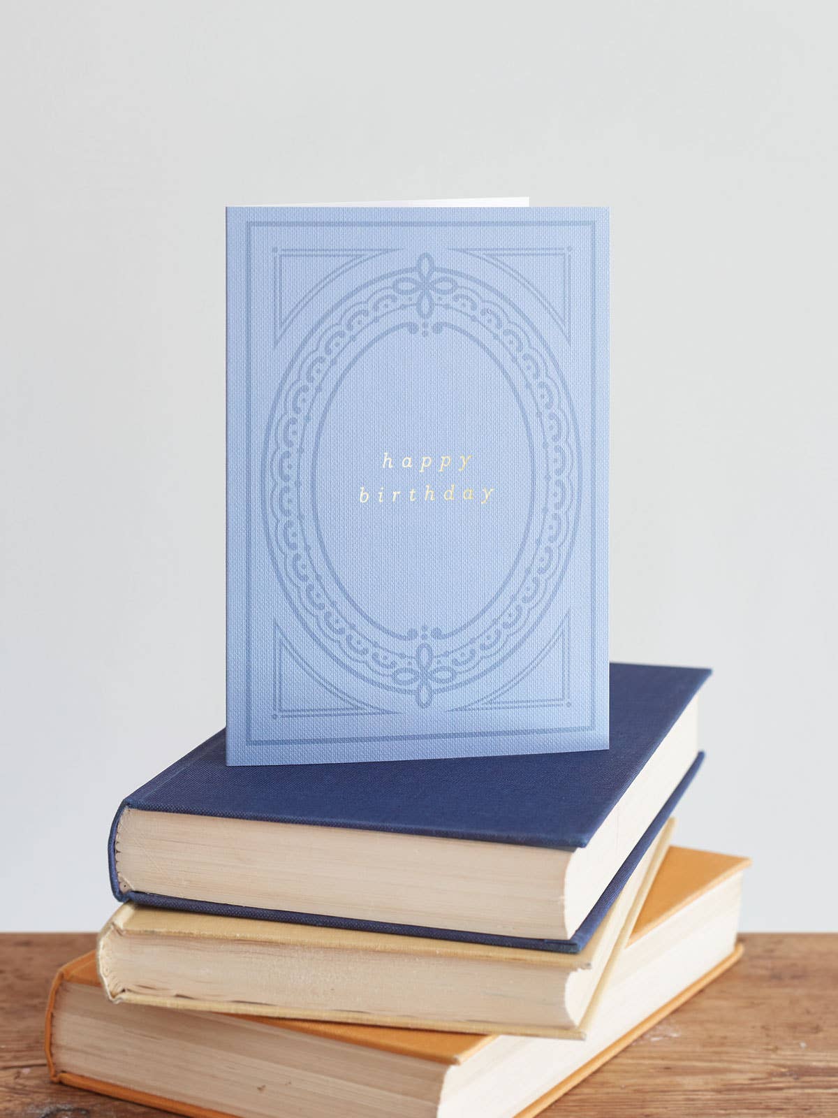 Hand-pressed gold foil details on blue buckram-textured birthday card