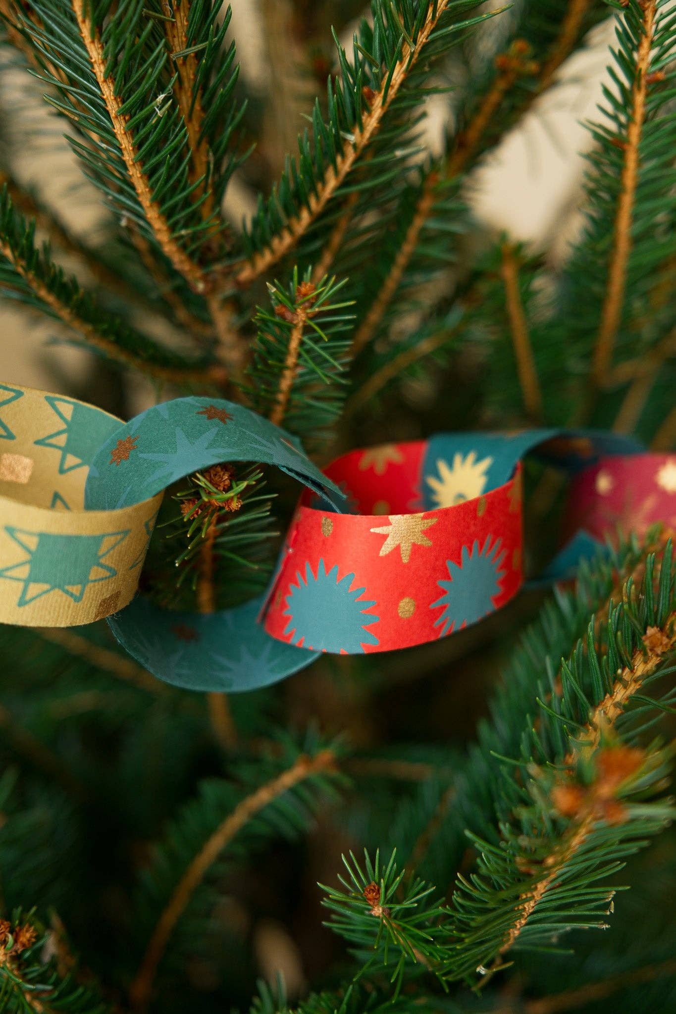 Recycled festive paper chain strips, hand-printed double-sided, eco-friendly decoration kit.