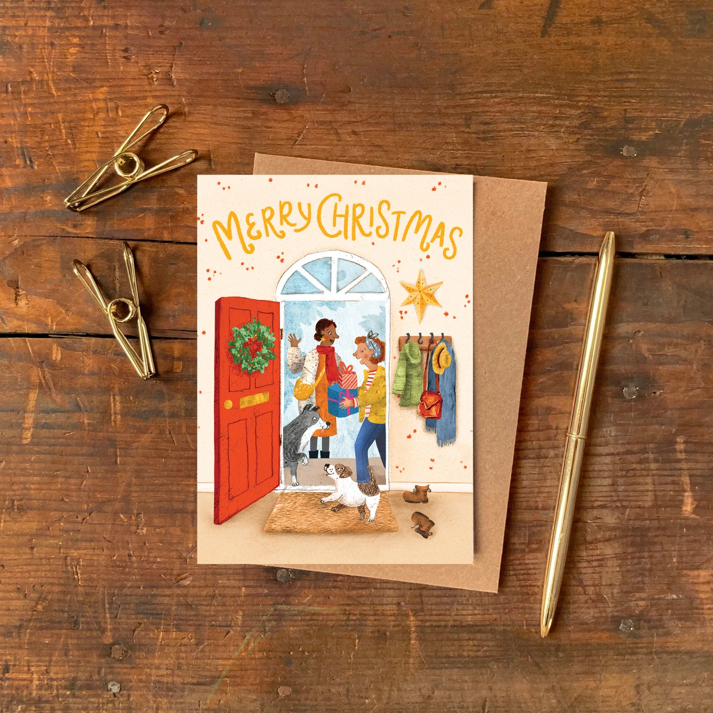 A6 greeting card illustrated by Emily Nash showing a cosy holiday house with guests arriving, printed on eco matte card with a 100% recycled kraft envelope.