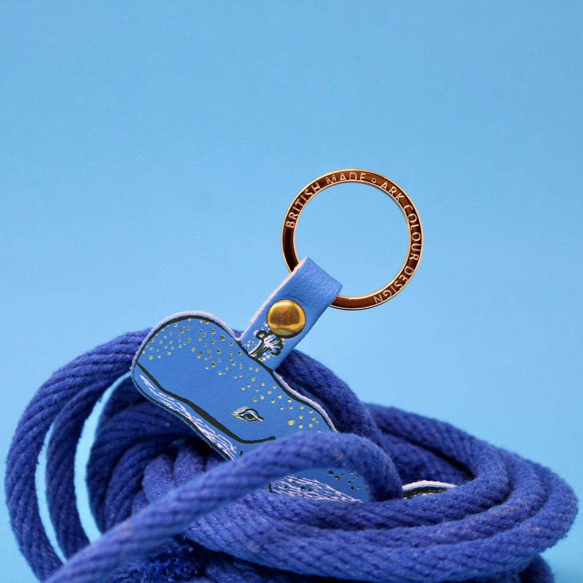 Close up of gold plated ring on leather whale keyring
