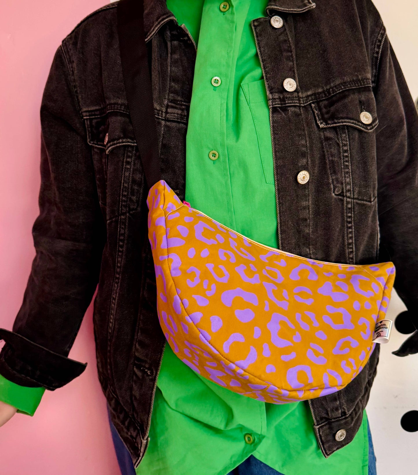 Model wearing Handprinted Waxed Canvas Sling Bag, side view