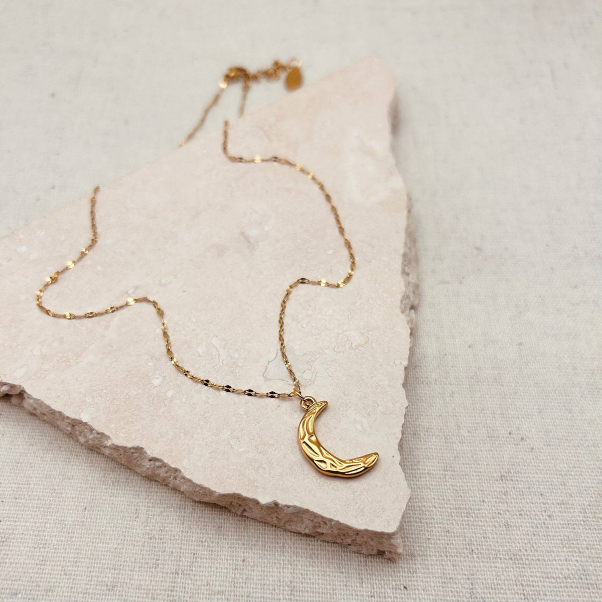 Everyday Hammered Gold Moon Necklace on a delicate petal chain