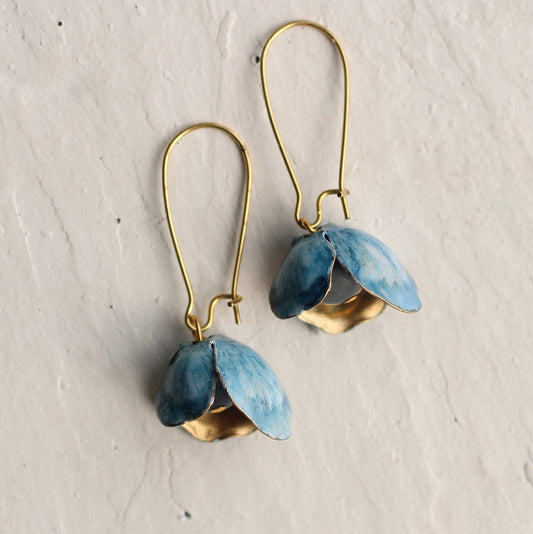 These unusual and beautiful bluebell earrings are made from vintage glass beads, layered with golden brass petals. The brass has flecks of rich blue and white paint which pick out the delicate blue of the bead underneath. The earrings are made of vintage glass and solid brass wire, and measure exactly two inches (5cm) in length.