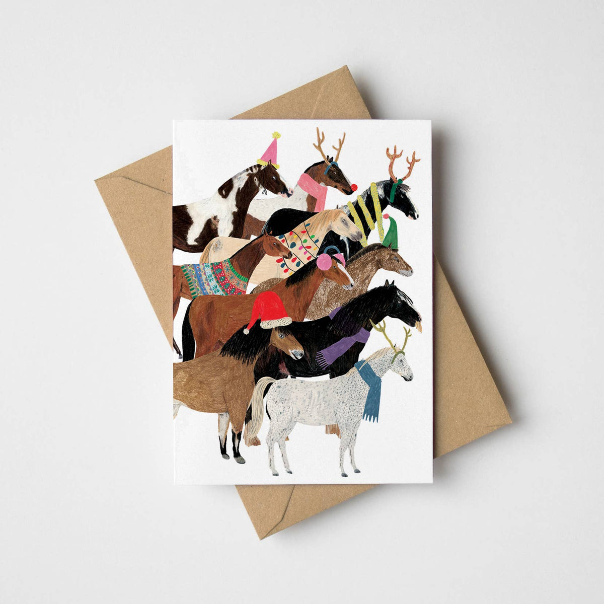 Christmas Ponies greeting card featuring festive horse breeds with Kraft envelope