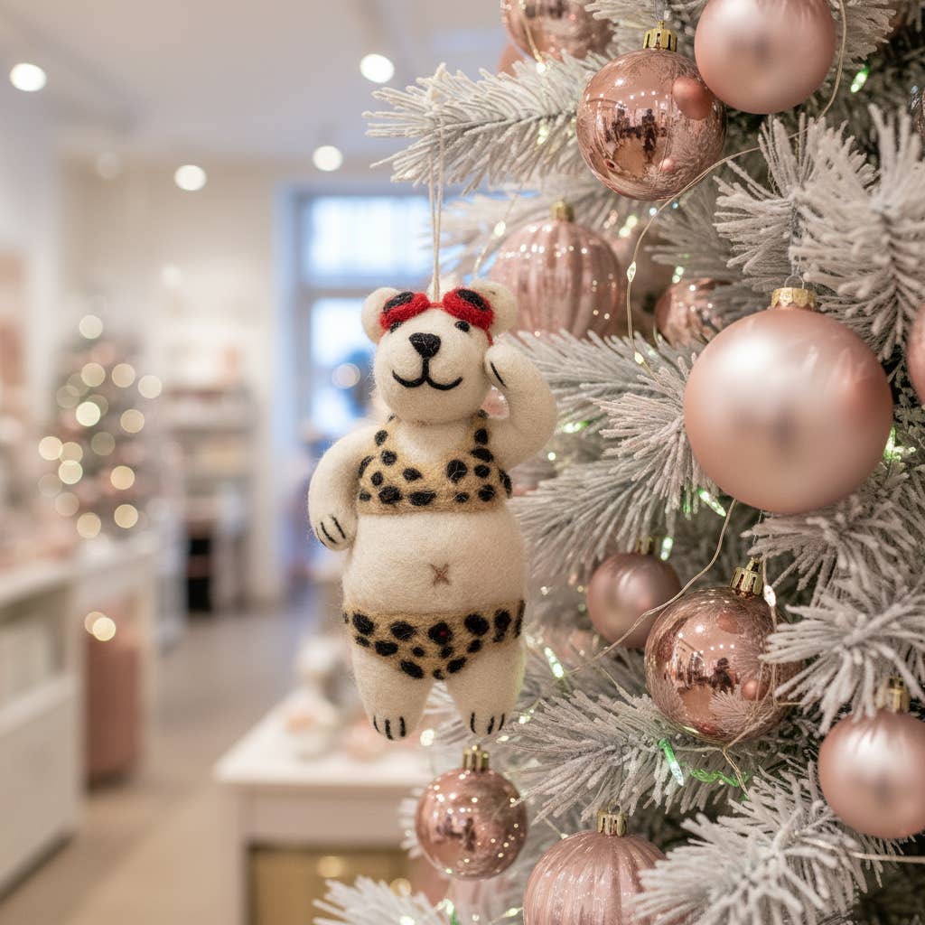 Biodegradable felt diva polar bear tree ornament hanging on festive branch
