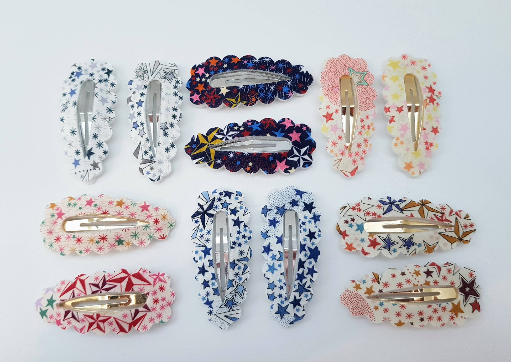Collection of colourful hair accessories including clips on a white background