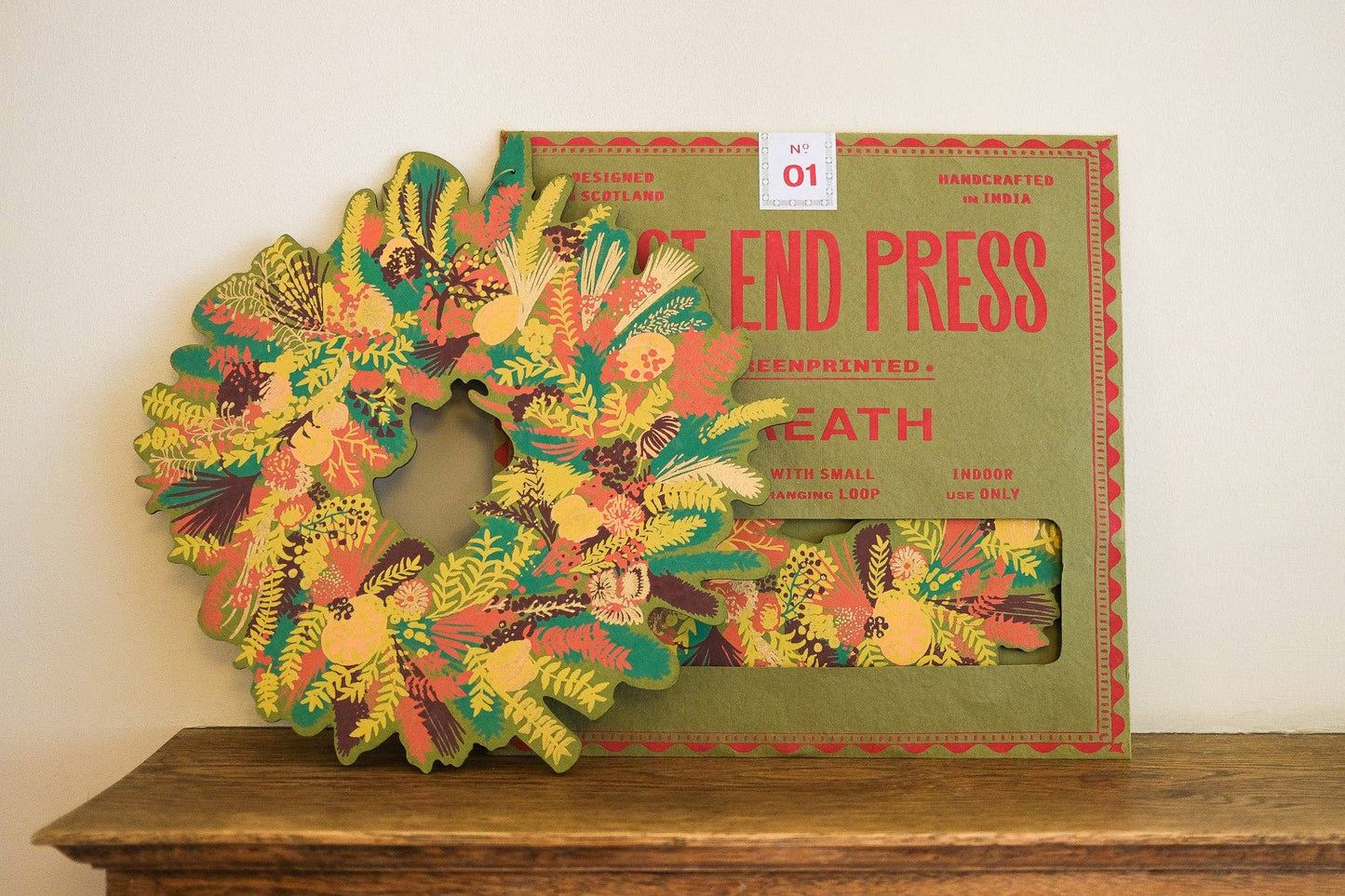 Hand-printed cotton board wreath with winter blooms, sustainable Christmas ornament