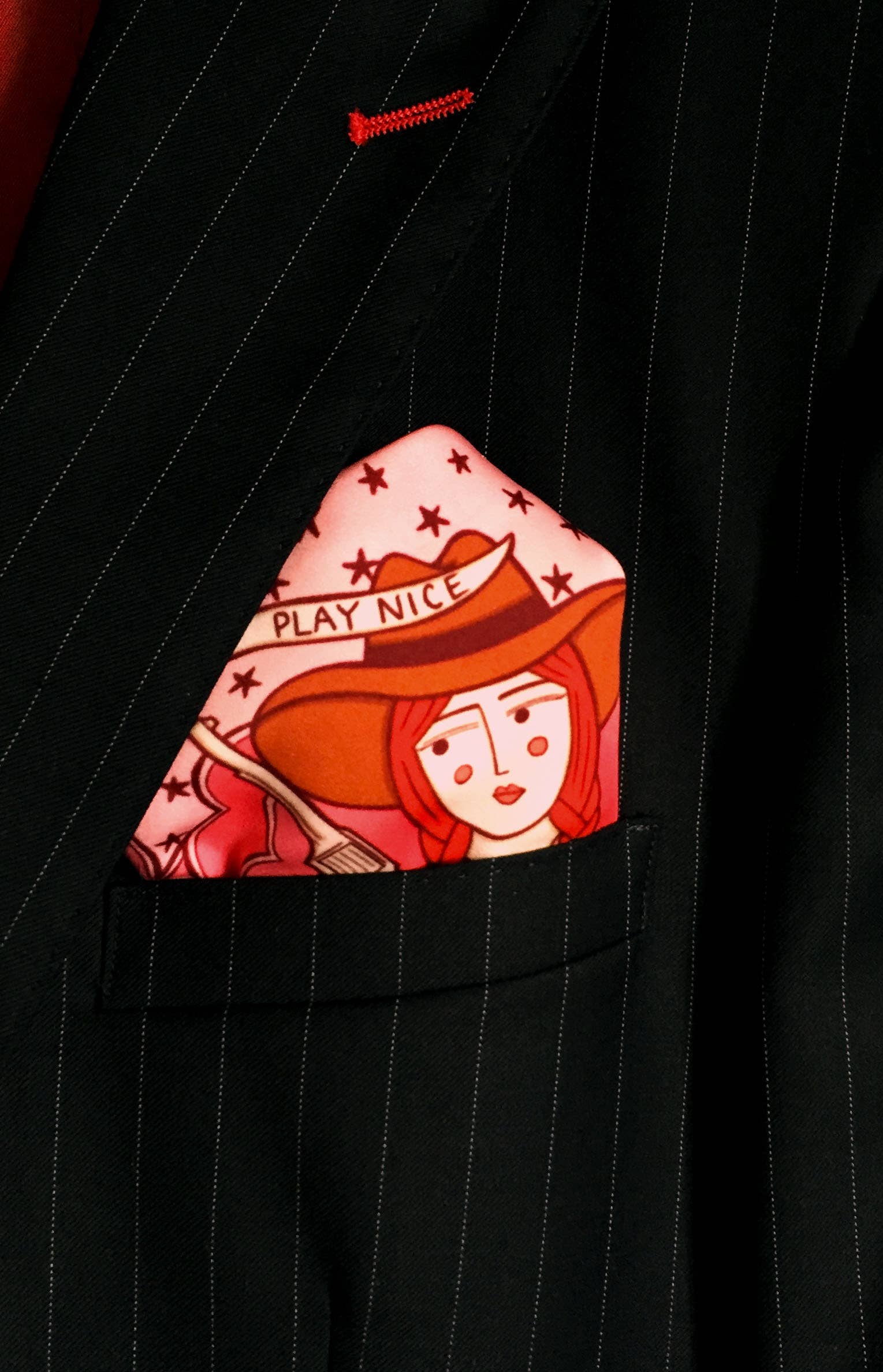 Eco silk twill pocket square with sassy cowgirl and white stallion, cacti, stars, boots, snakes, mountains, and horseshoe border in red and pink. Made from recycled polyester, designed by Su Owen.