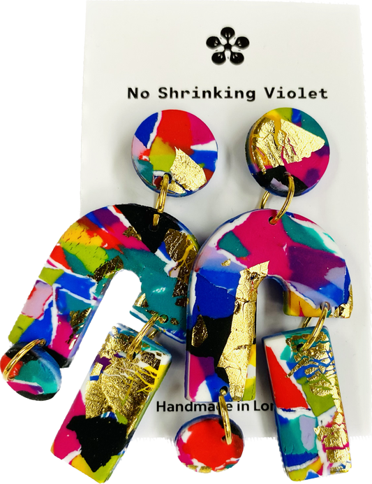 Close-up of vibrant polymer clay statement earrings with gold accents, nickel-free.