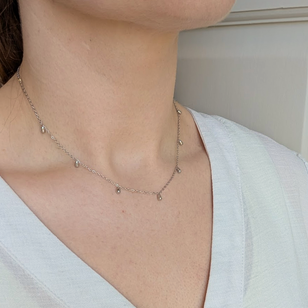 Close up of the Silver Mini Droplet Necklace showing the pendants