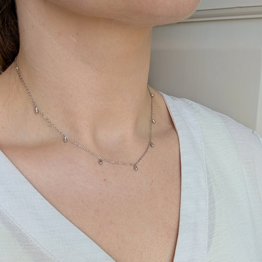 Close up of the Silver Mini Droplet Necklace showing the pendants