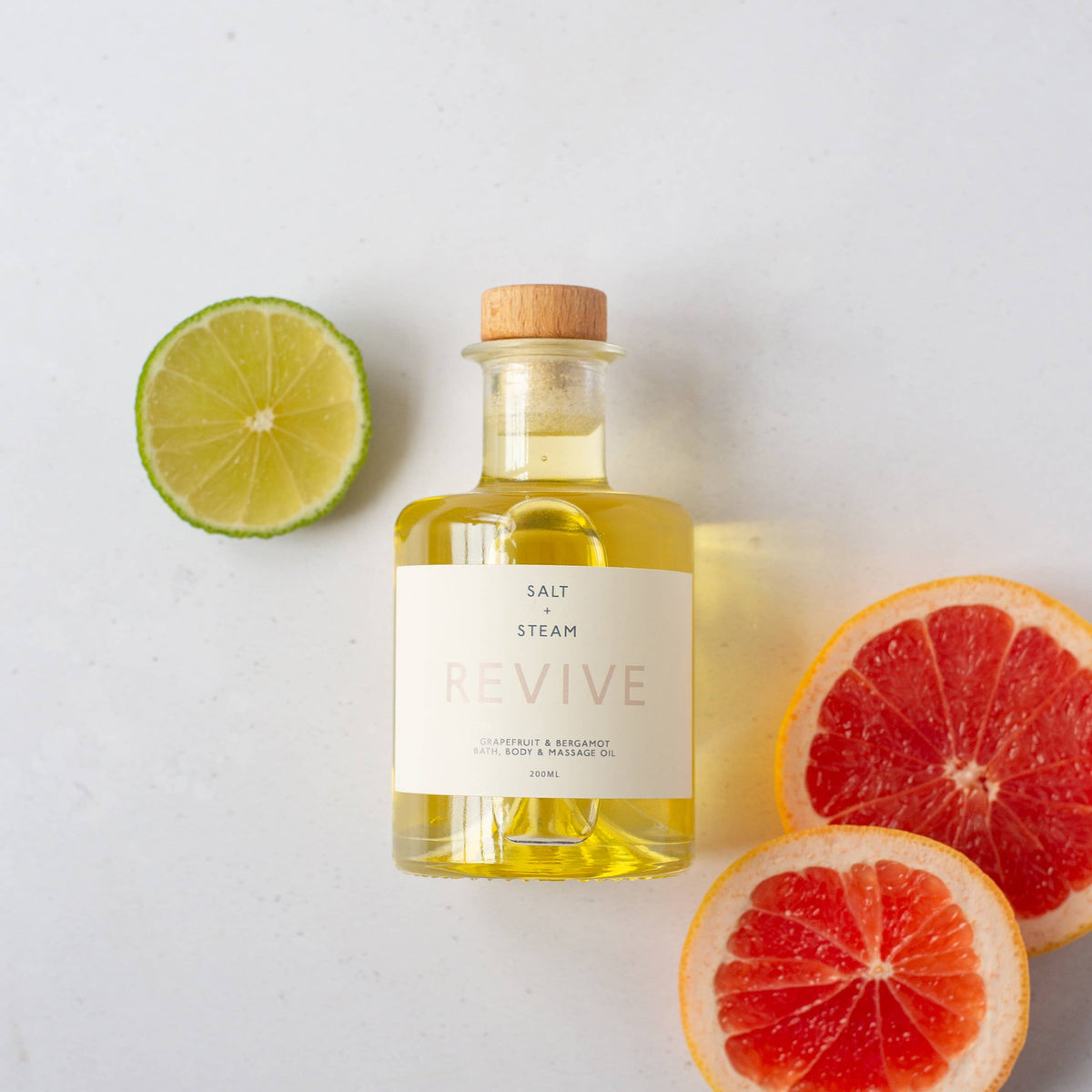 Revive Grapefruit and Bergamot Bath and Body Oil in glass bottle