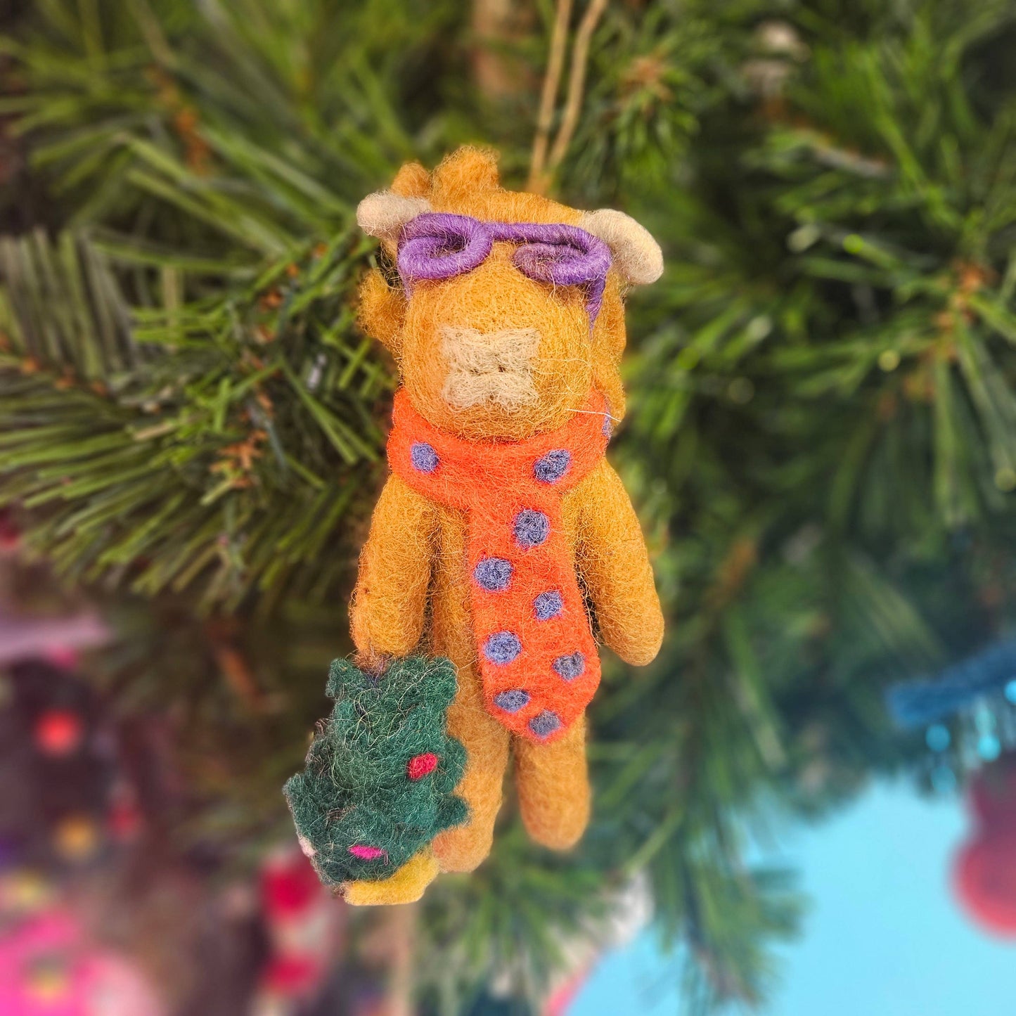 Handmade felt Christmas Cow hanging decoration "Curtis" by Felt So Good, sustainable wool with purple glasses, fair trade and eco-friendly