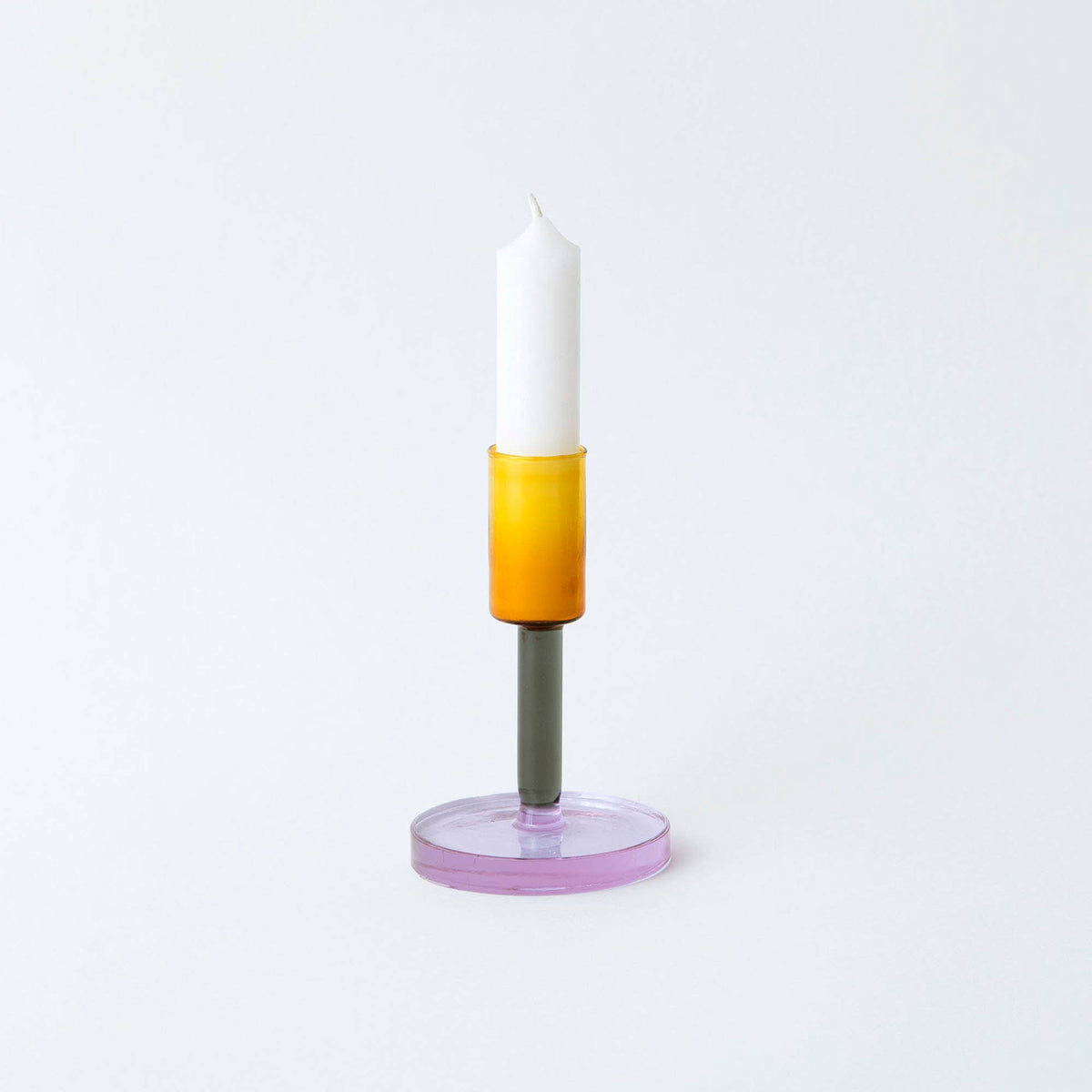 Close up of smoke and amber glass candlestick holder wide base