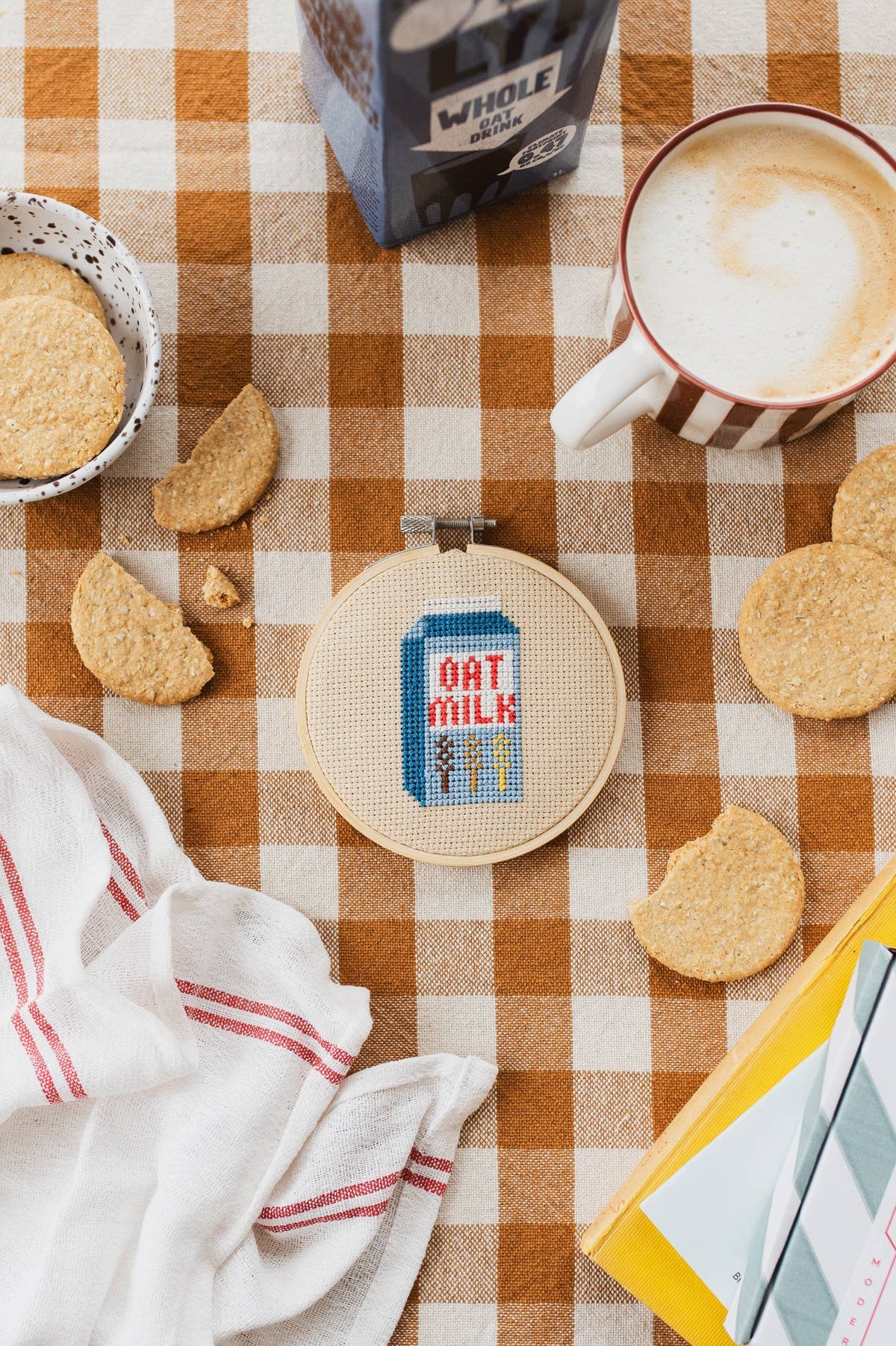 Finished 4-inch retro oat milk carton cross stitch in bamboo hoop