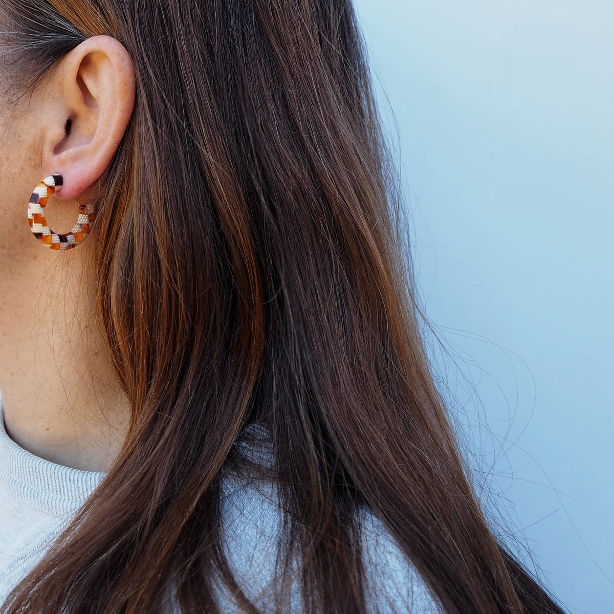 Close up of honey mix checker pattern on chunky hoop earrings