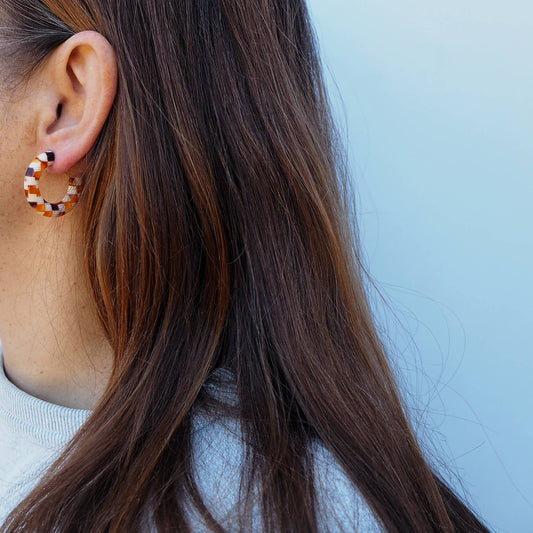 Close up of honey mix checker pattern on chunky hoop earrings