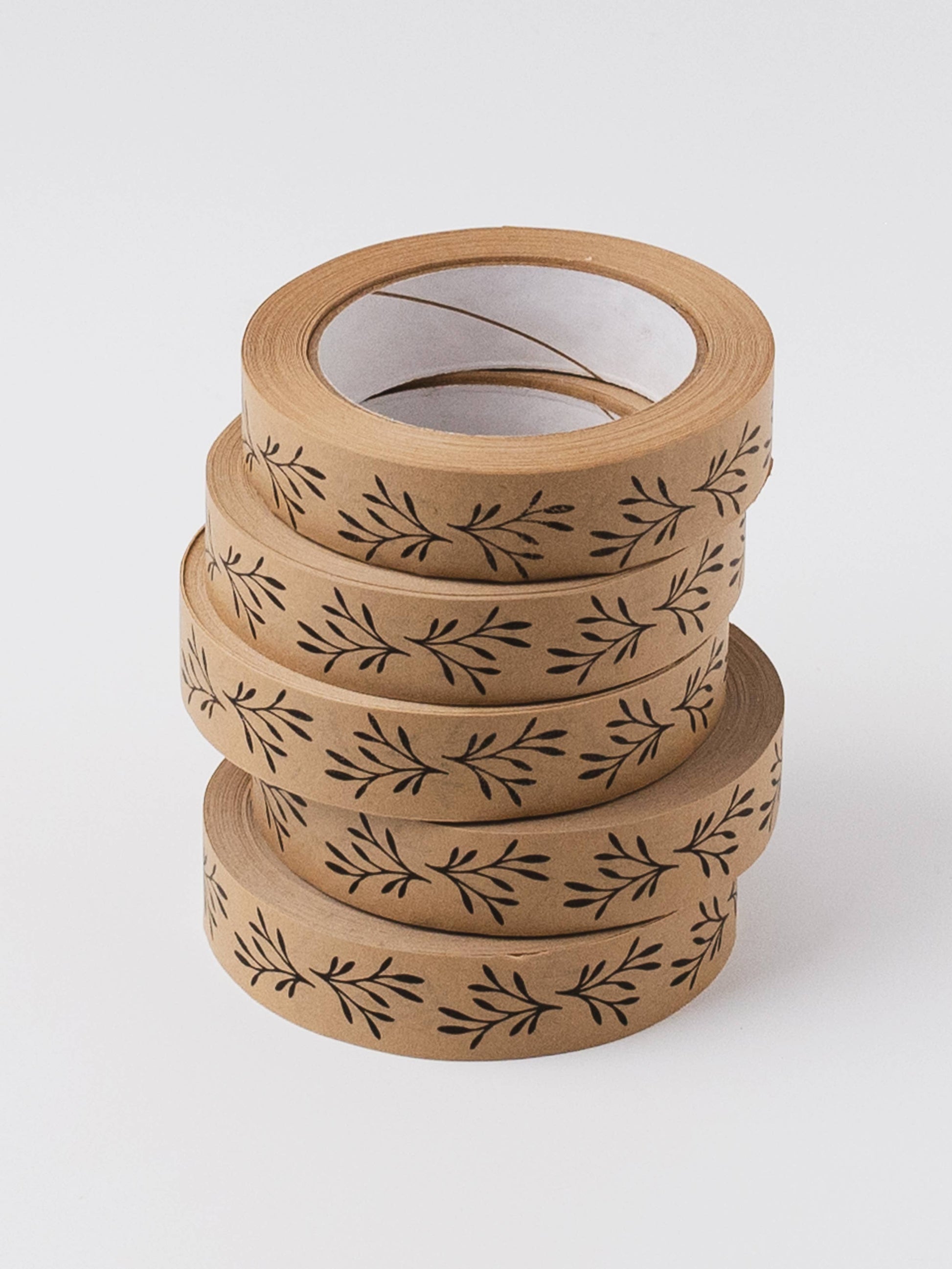 Hand easily tearing sustainable floral kraft paper tape without scissors