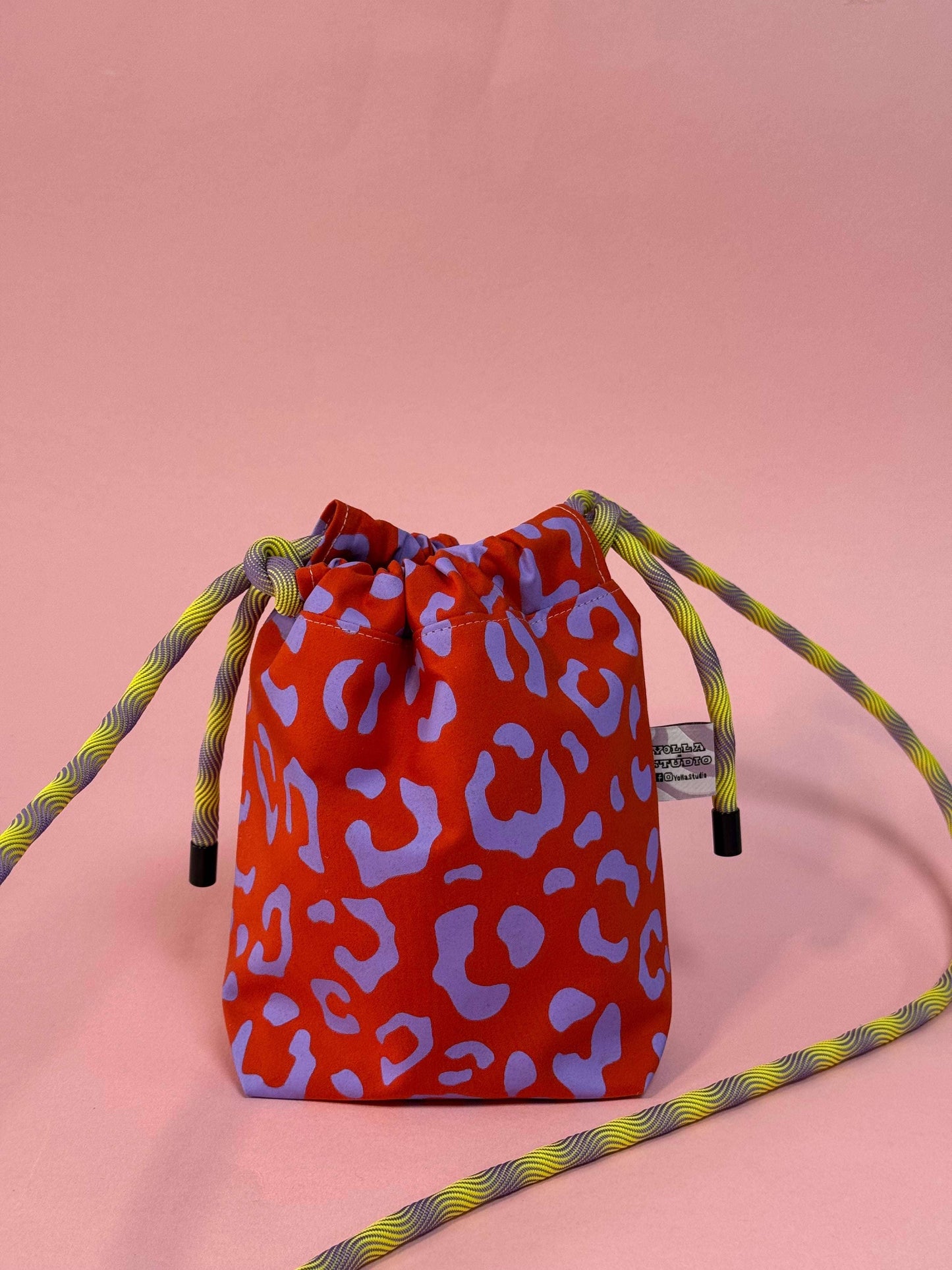 Handmade purple and red leopard print dog walking bag worn crossbody