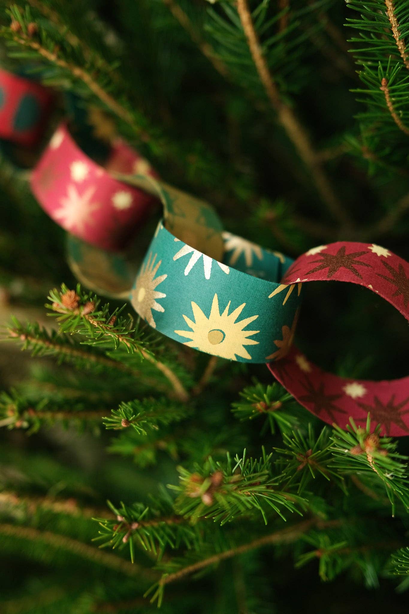 Recycled festive paper chain strips, hand-printed double-sided, eco-friendly decoration kit.