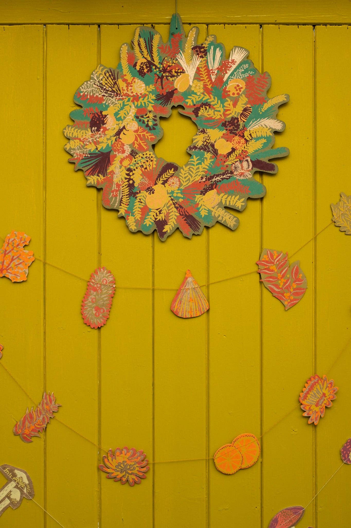 Hand-printed cotton board wreath with winter blooms, sustainable Christmas ornament
