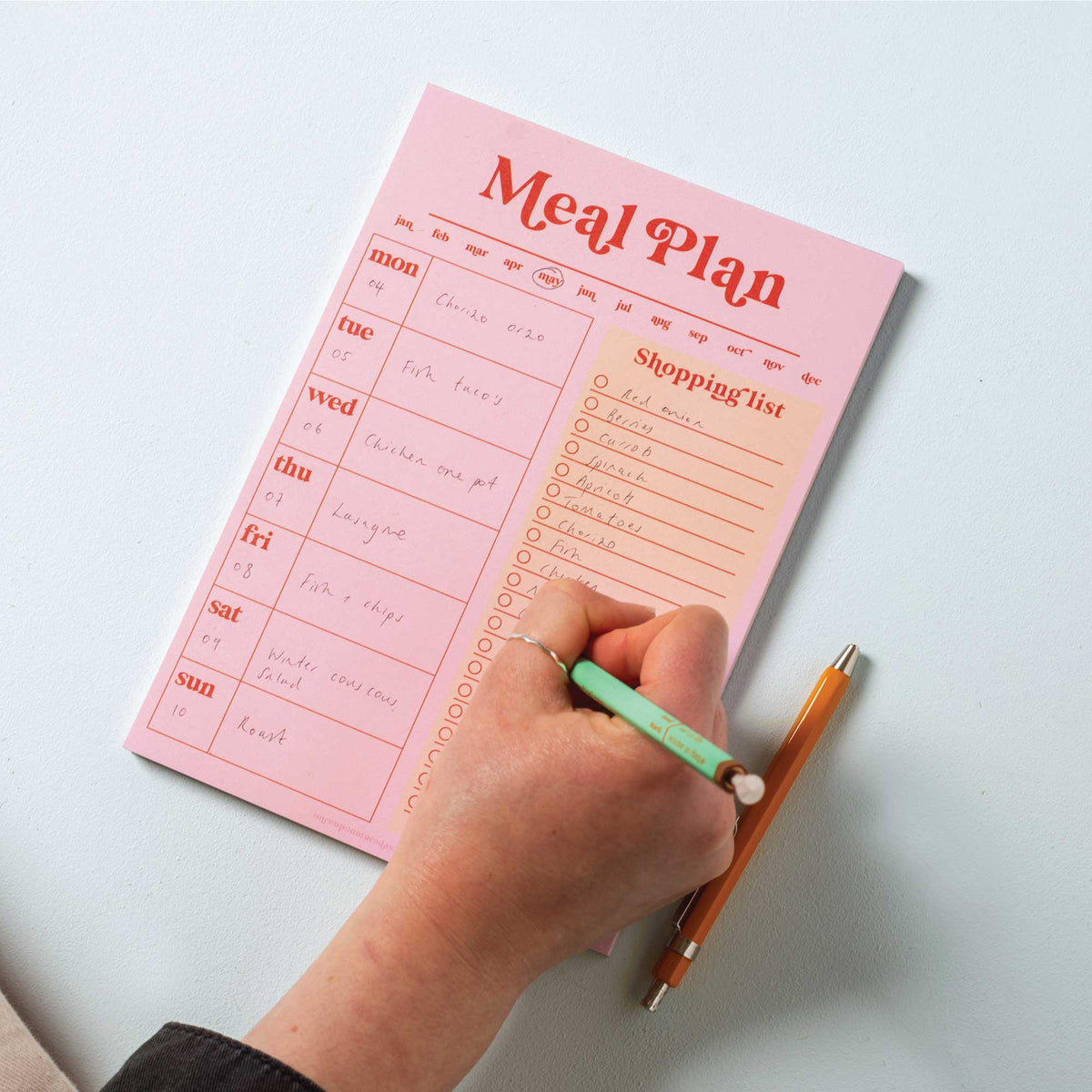Close up of the Pink and Red meal planner pad pages