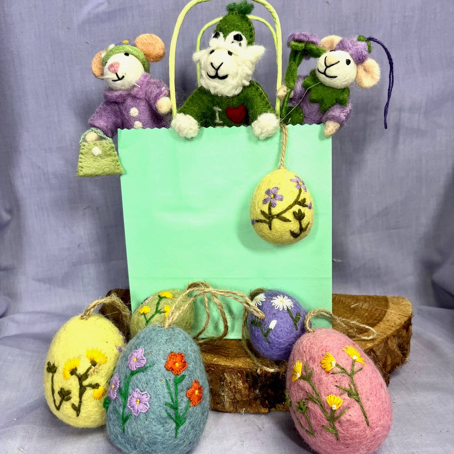 Pastel coloured hand embroidered felt egg featuring delicate floral embroidery. Each egg is meticulously hand stitched, showcasing intricate details and vibrant colours that will add a touch of elegance to your home.