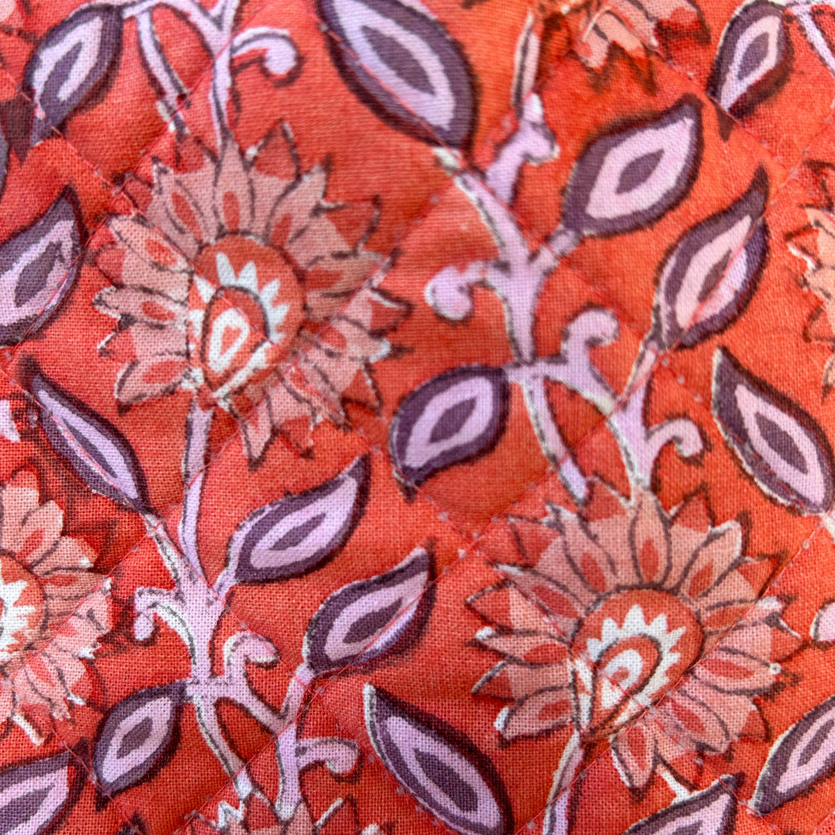 Artisan handmade cotton hot water bottle in coral and lilac