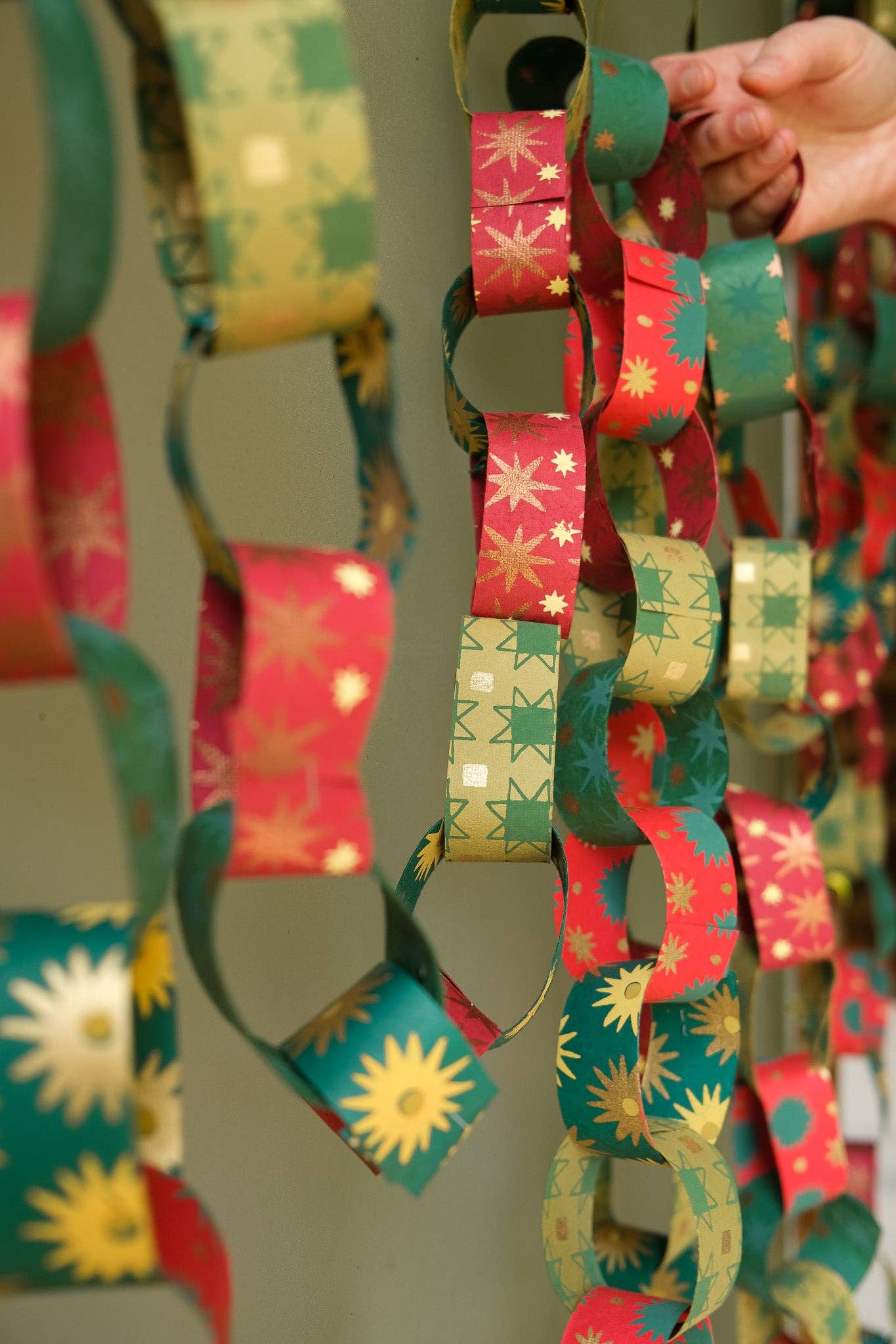 Recycled festive paper chain strips, hand-printed double-sided, eco-friendly decoration kit.