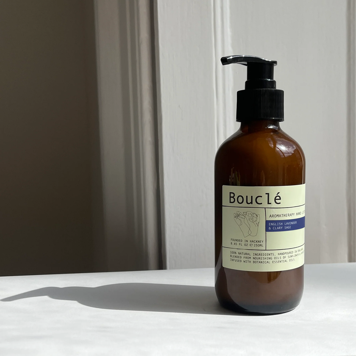 Natural ingredients hand lotion close up showing the elegant amber glass packaging