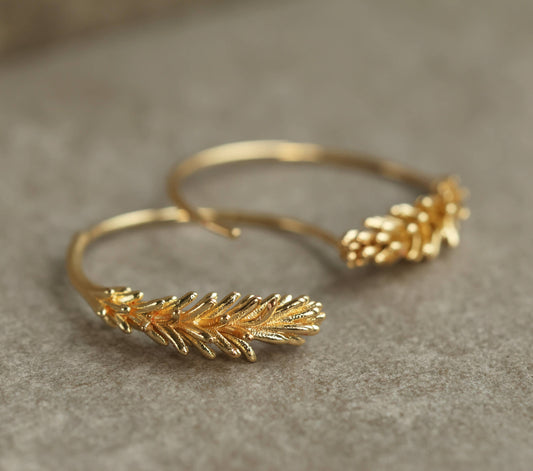 These rosemary leaf hoop earrings are made from plated brass with some amazing detail on the leaves. They feature a detailed botanical sprig of leaves, in a choice of gold. The hoop earrings measure 30mm in diameter and come with butterfly earring backs for a secure fit.

Designed and crafted in the UK.