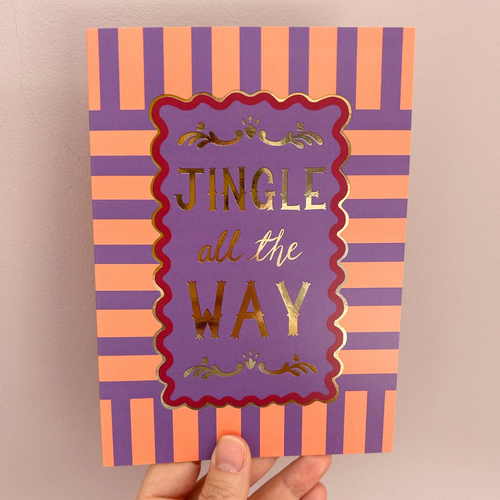 Stack of Jingle All The Way Christmas Cards with Paper Band, showcasing plastic-free packaging