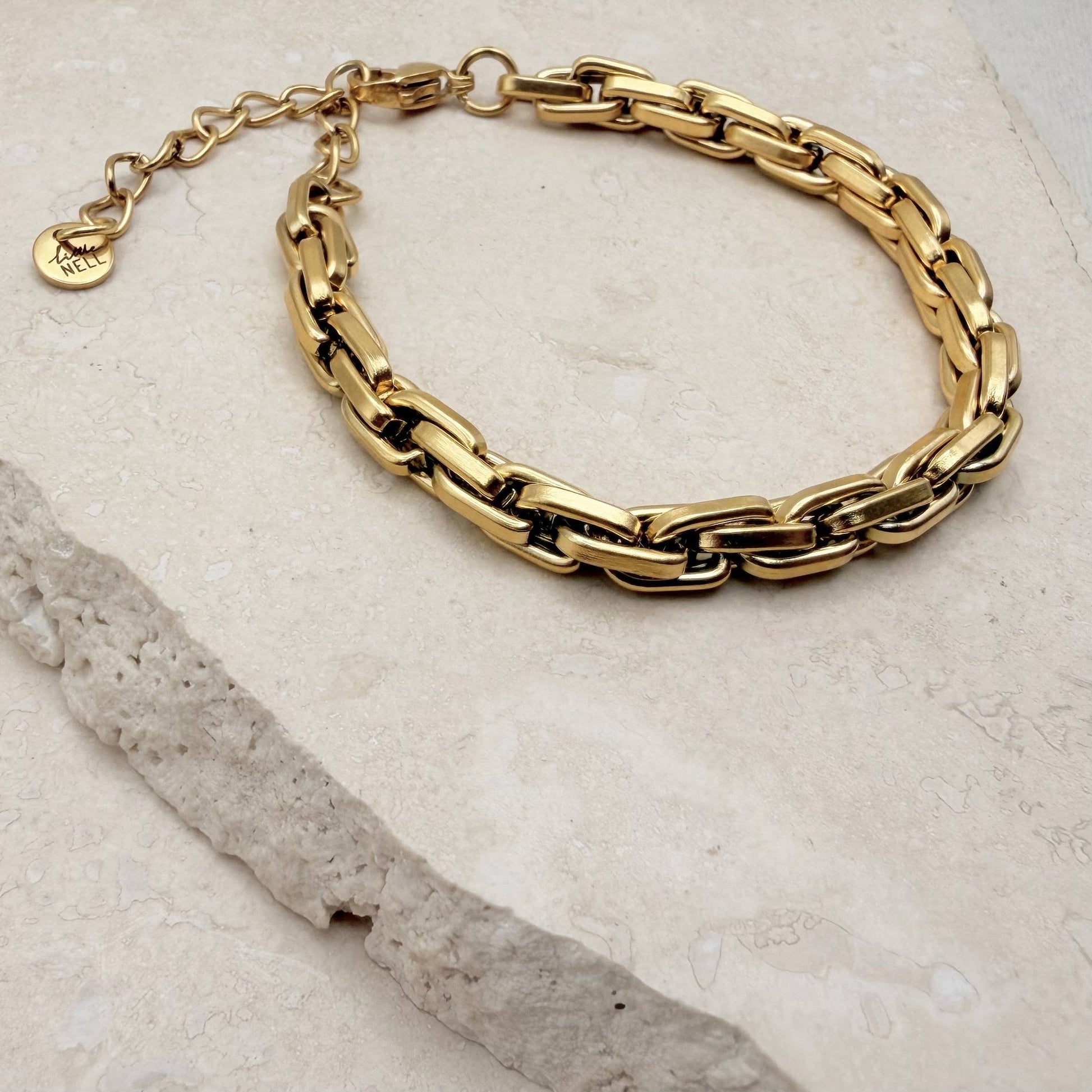 Stacked gold box chain bracelet on wrist
