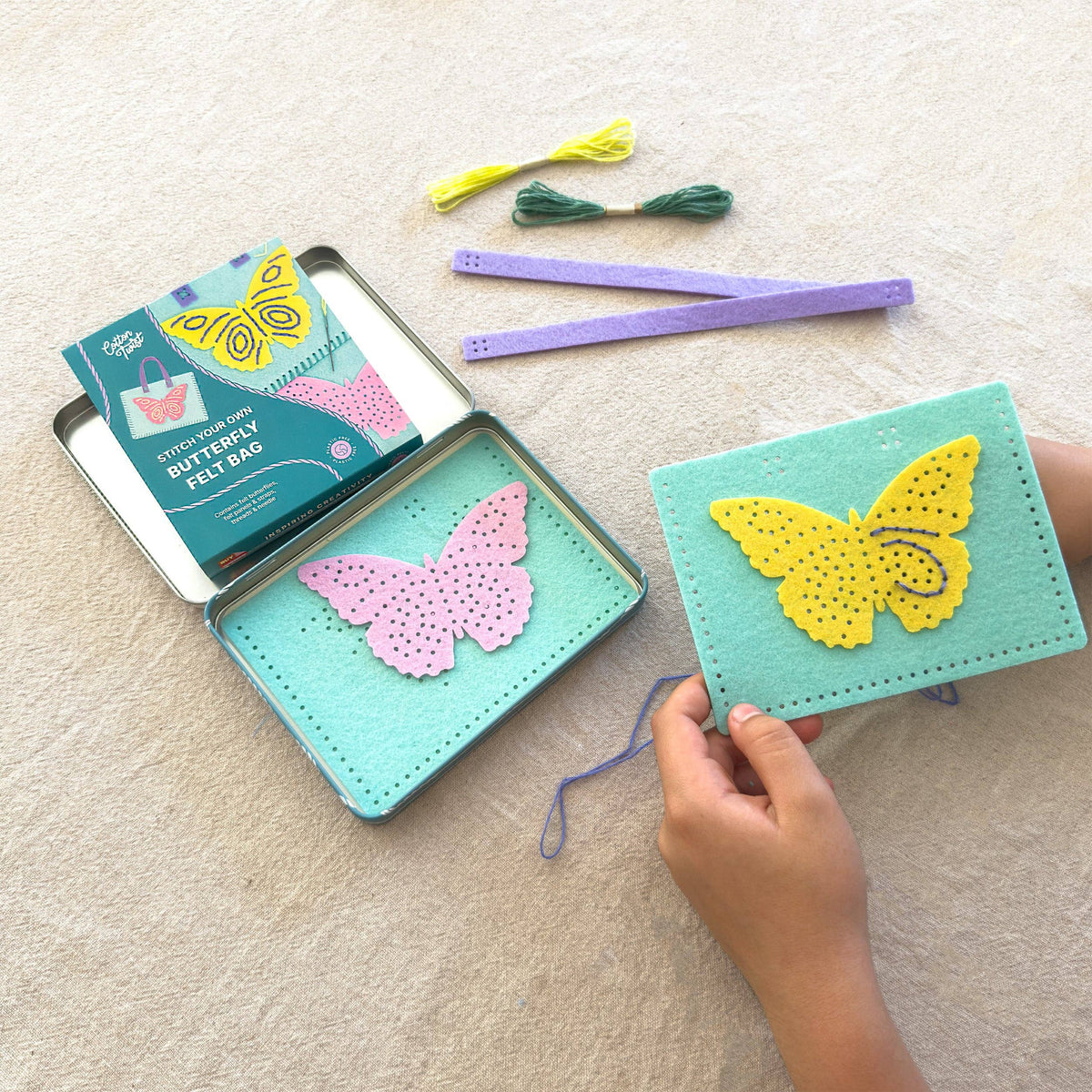 Child proudly wearing their handmade butterfly felt bag