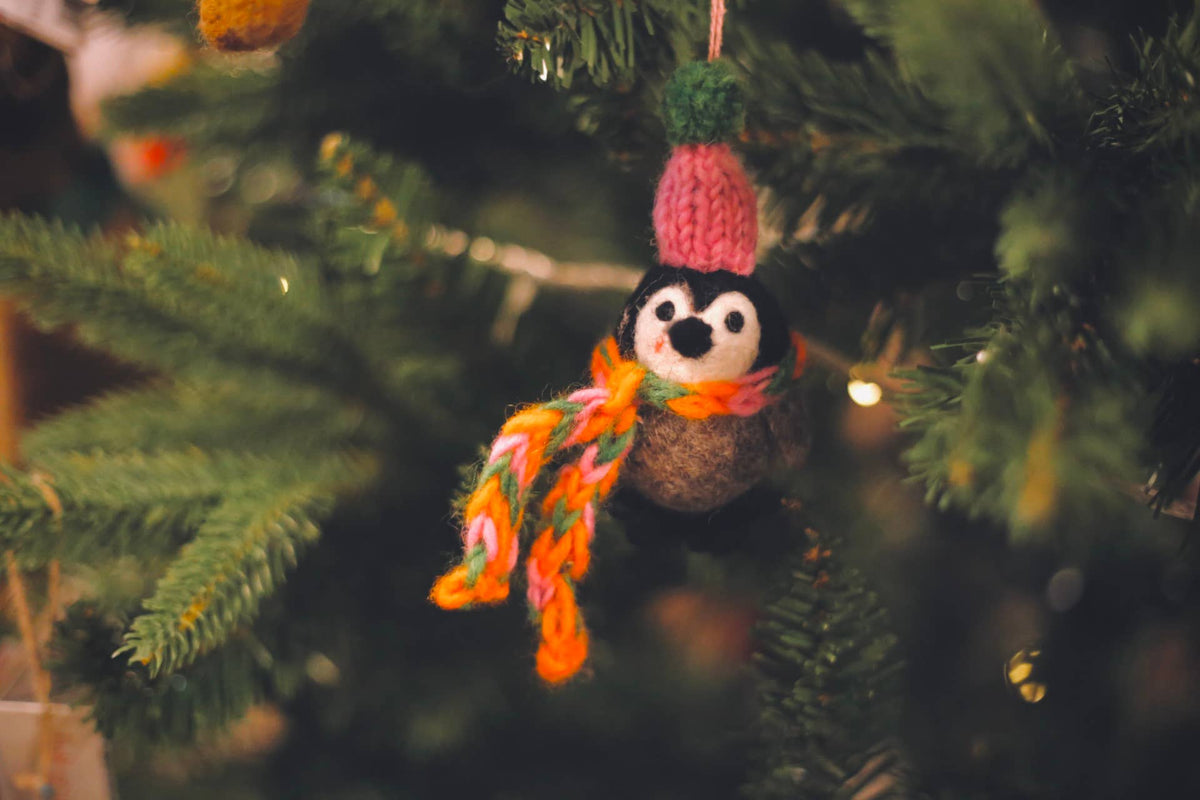 Handcrafted felt penguin with knitted winter accessories