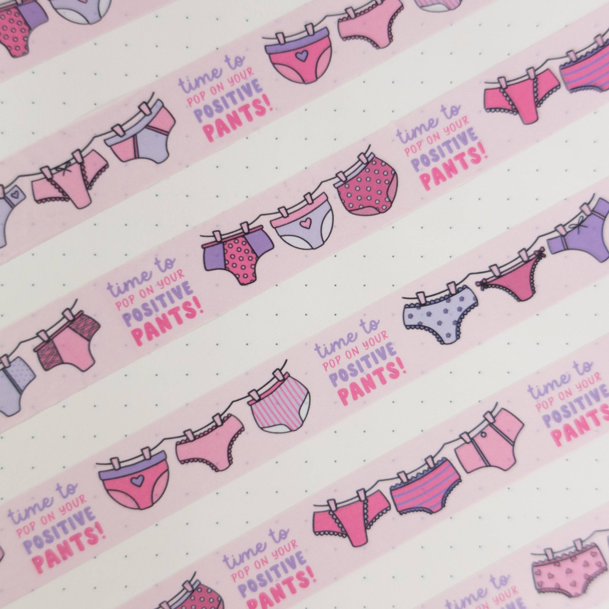Pink and purple patterned pants washi tape with “pop on your positive pants” message and eco-friendly paper packaging—perfect for uplifting journaling and craft projects.