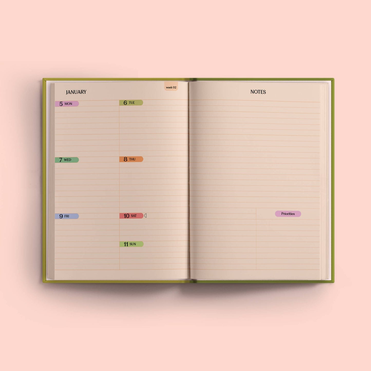 Open planner with dates and notes on a pink background