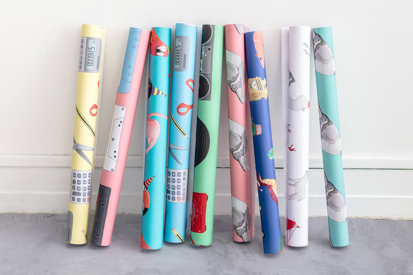 Assorted rolls of eco-friendly gift wrap in floral and retro designs