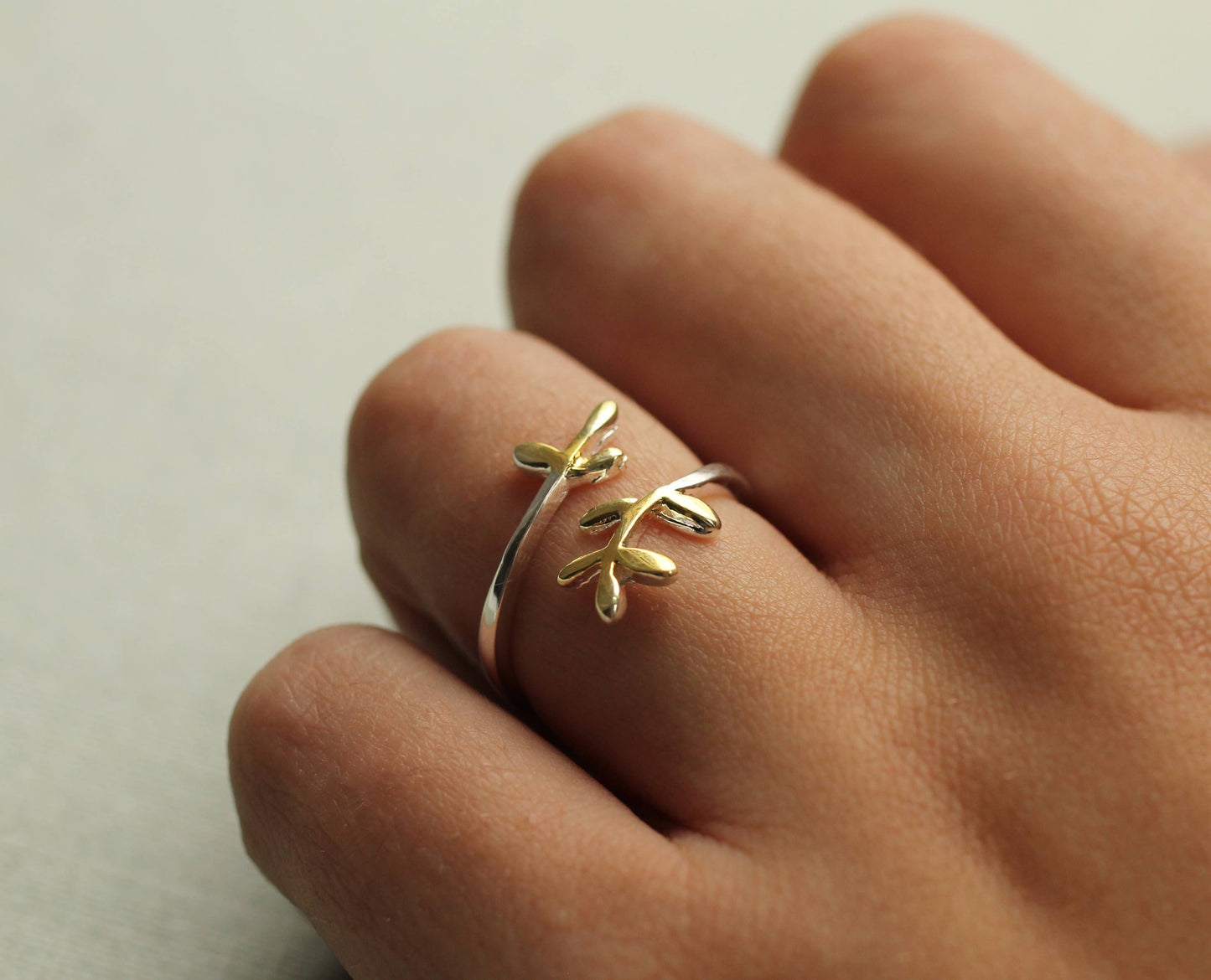 This sweet and delicate botanical inspired ring is made from Sterling silver, with touches of gold plating on the tips. The ring has an open, or adjustable form which can fit most fingers.