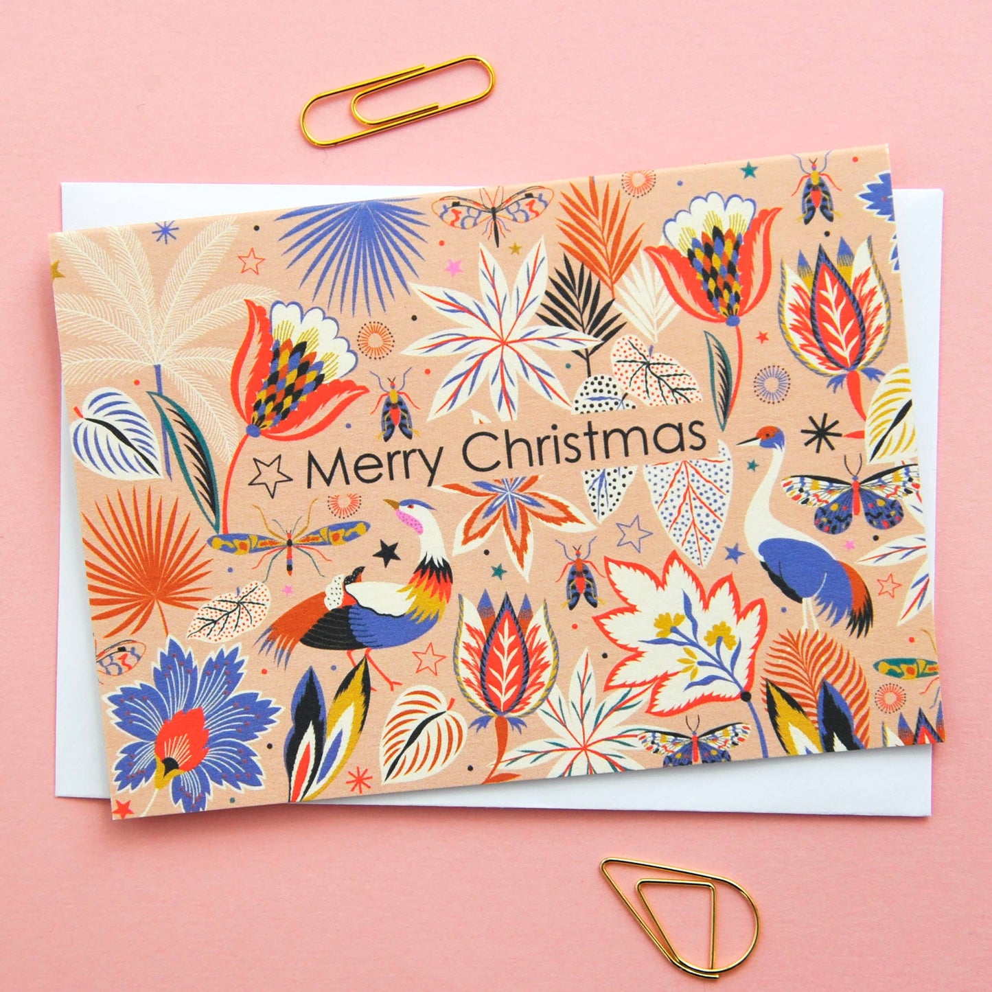 Festive Christmas notecard with colourful flora and fauna illustration on a neutral background, 'Merry Christmas' text.