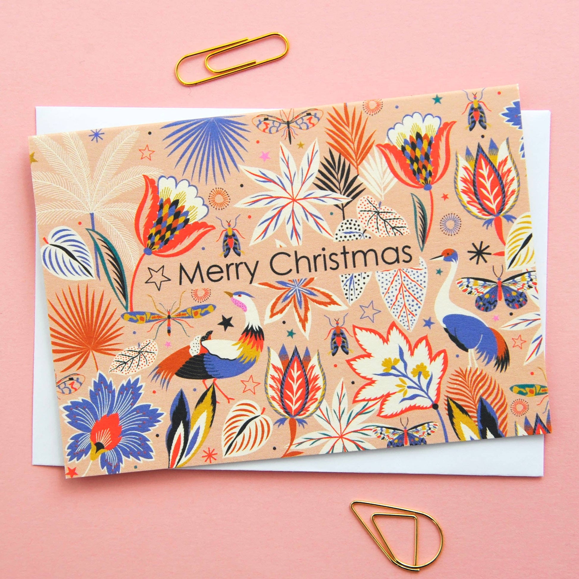 Festive Christmas notecard with colourful flora and fauna illustration on a neutral background, 'Merry Christmas' text.
