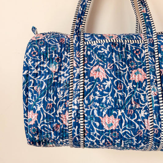 Inside view of quilted cotton weekend bag showing striped lining and pocket