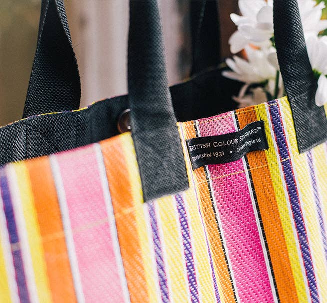 Eco Woven Market Shopper in Neyron, Guardsman and Pearl. A colourful, sustainable shopper with sturdy handles and a magnetic popper closure. This bag is made from threads spun from recycling old cement sacks!