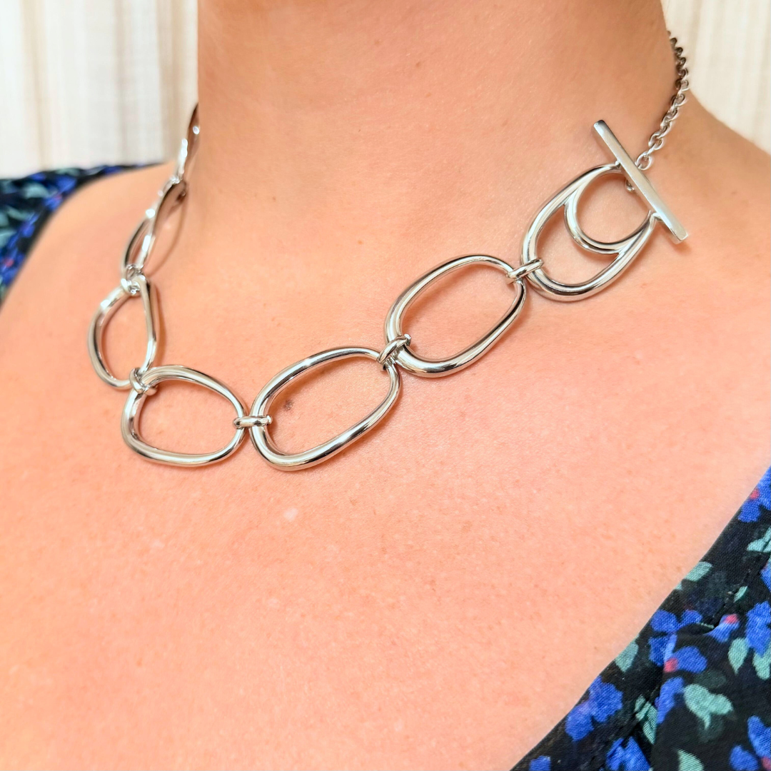 Model wearing Little Nell Silver Pebble Link Statement Necklace, highlighting its modern design